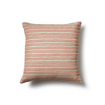 Square throw pillow in a striped pattern of hand-drawn red and pink honeycomb shapes on a cream background.
