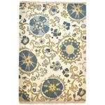 Rectangular fringed rug in a floral pattern in shades of blue, green and gray on a cream field.