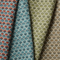 A row of four folded fabric swatches all in different colorways of the same Japanese-inspired scalloped pattern. 