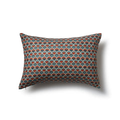 Rectangular throw pillow with a repeating Japanese-inspired scalloped pattern in shades of blue, red and cream.