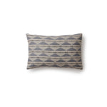 Rectangular throw pillow in a linear pattern with a sand dune-shaped triangle stripe motif in shades of navy, light blue and gray.