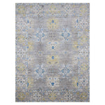 Rectangular rug in a dense floral pattern with a floral border in shades of blue, gray and yellow on a light gray field.