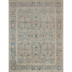 Large rectangular rug in a repeating geometric print with a floral border in shades of blue-gray, rust and navy.