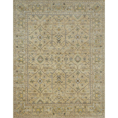 Large rectangular rug in a repeating geometric print with a floral border in shades of cream, gold and brown.