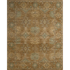 Large rectangular rug in a repeating geometric print with a floral border in shades of gold, brown and blue-gray.