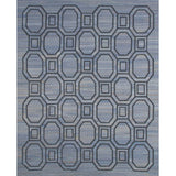 Rectangular rug with an interlocking octagon and square pattern in navy blue on a mottled blue background.