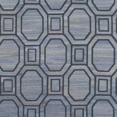 Woven rug swatch with an interlocking octagon and square pattern in navy blue on a mottled blue background.