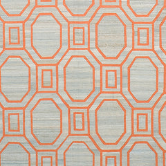 Woven rug swatch with an interlocking octagon and square pattern in bright coral on a tan background.