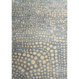 Large rectangular rug in a small-scale pattern of many repeating different-sized circles in tan on a blue-gray field.