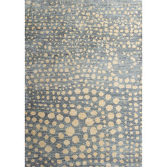 Large rectangular rug in a small-scale pattern of many repeating different-sized circles in tan on a blue-gray field.