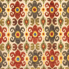 Woven rug swatch in a repeating ikat floral pattern in shades of red, yellow and green on a tan field.
