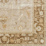 Woven rug swatch with a repeating abstract foral pattern and a dense floral border in shades of white, tan and brown.