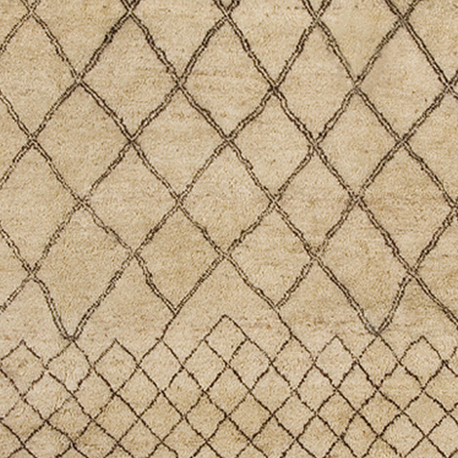 Woven rug swatch in a large-scale diamond pattern that transitions to a smaller-scale diamond pattern in black lines on a tan field.