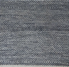 Woven rug swatch with a small-scale diamond pattern in black on a blue-gray field.