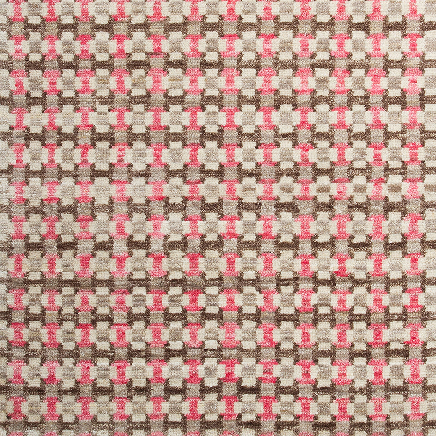 Woven rug swatch in a small-scale grid pattern featuring squares of white, pink, tan and brown.