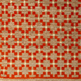 Woven rug swatch in a large-scale grid pattern featuring squares of red, tan and cream.