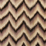 Woven rug swatch in an Ikat chevron pattern in shades of cream, tan, brown and black.