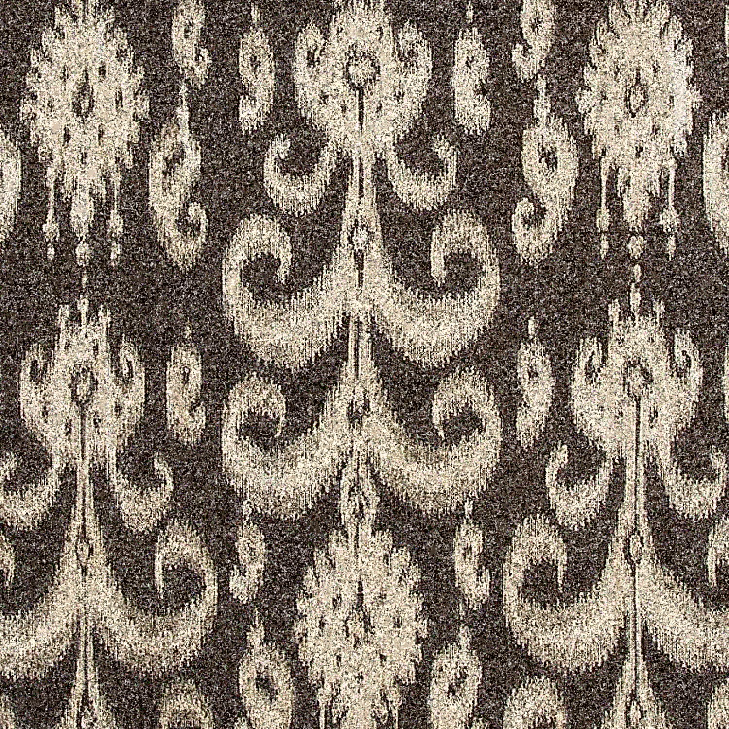Detail of a woven rug with a cream ikat fleur de lis pattern on a black field.