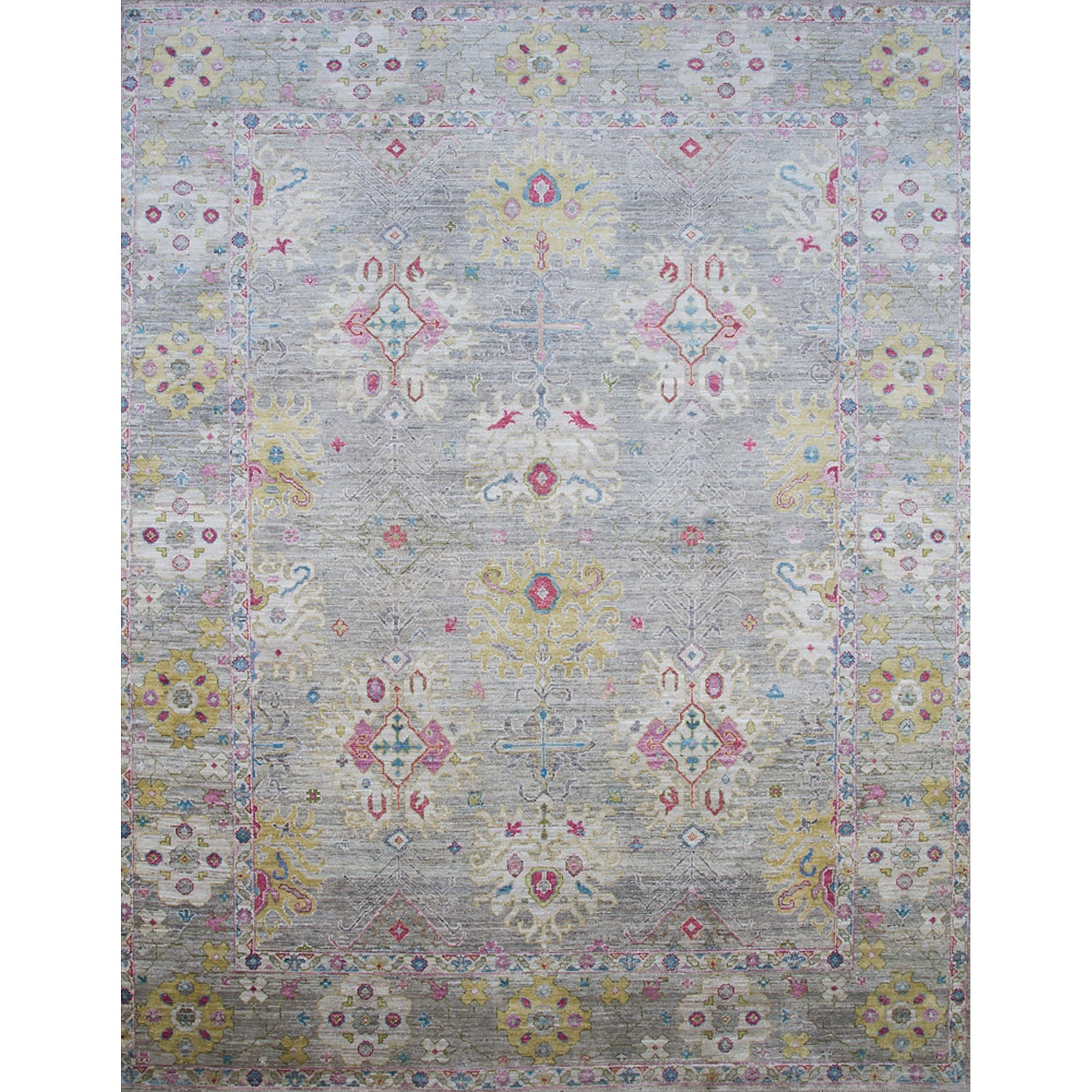 Large rectangular rug in an abstract floral pattern with a repeating floral border print in shades of pink, yellow and red on a mottled gray field.