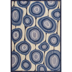 Rectangular in an abstract circular pattern reminiscent of lollipops in shades of blue and gray on a tan field.