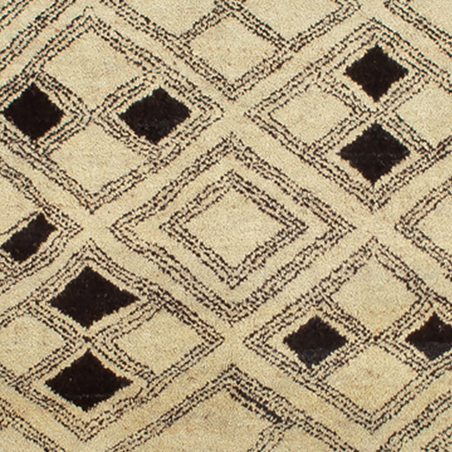 Woven high-pile rug swatch in a pattern of graduating diamond shapes in dark brown on a tan field.