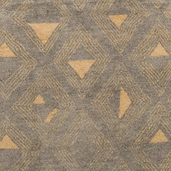 Woven high-pile rug swatch in an abstract pattern of graduating diamond shapes in tan on a gray field.
