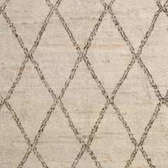 Woven high-pile rug swatch in a large scale diamond pattern in black on a tan field.