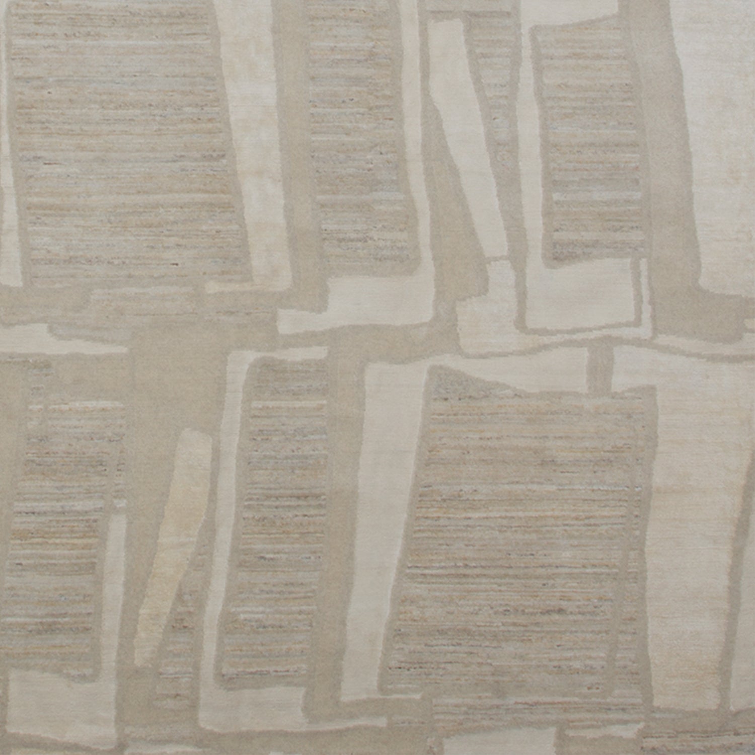 Woven rug swatch in an overlapping hand-drawn rectangle pattern in shades of cream and light gray.