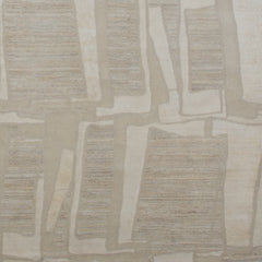 Woven rug swatch in an overlapping hand-drawn rectangle pattern in shades of cream and light gray.