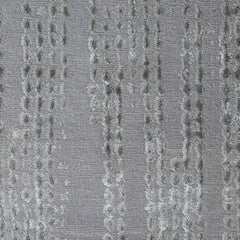 Woven high-pile rug swatch in gray with a repeating "raindrop" pattern in various shades of gray.