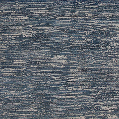 Woven rug swatch in a mottled stripe print in shades of blue, black and gray.