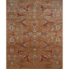 Large rectangular rug in a dense floral print in shades of red, pink and blue-gray on an orange field.