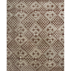 High-pile rectangular rug in a dense geometric pattern of diamonds in various sizes in shades of brown and cream.