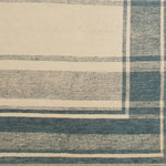 Woven rug swatch in a plaid woodgrain pattern in blue-gray on a tan field.