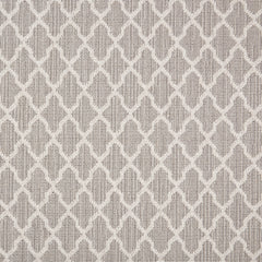 Wool-blend broadloom carpet swatch in a geometric lattice print in cream on a light brown field.
