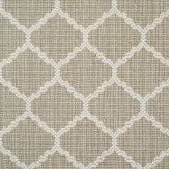 Wool-blend broadloom carpet swatch in a chunky lattice weave in cream on a mottled tan field.