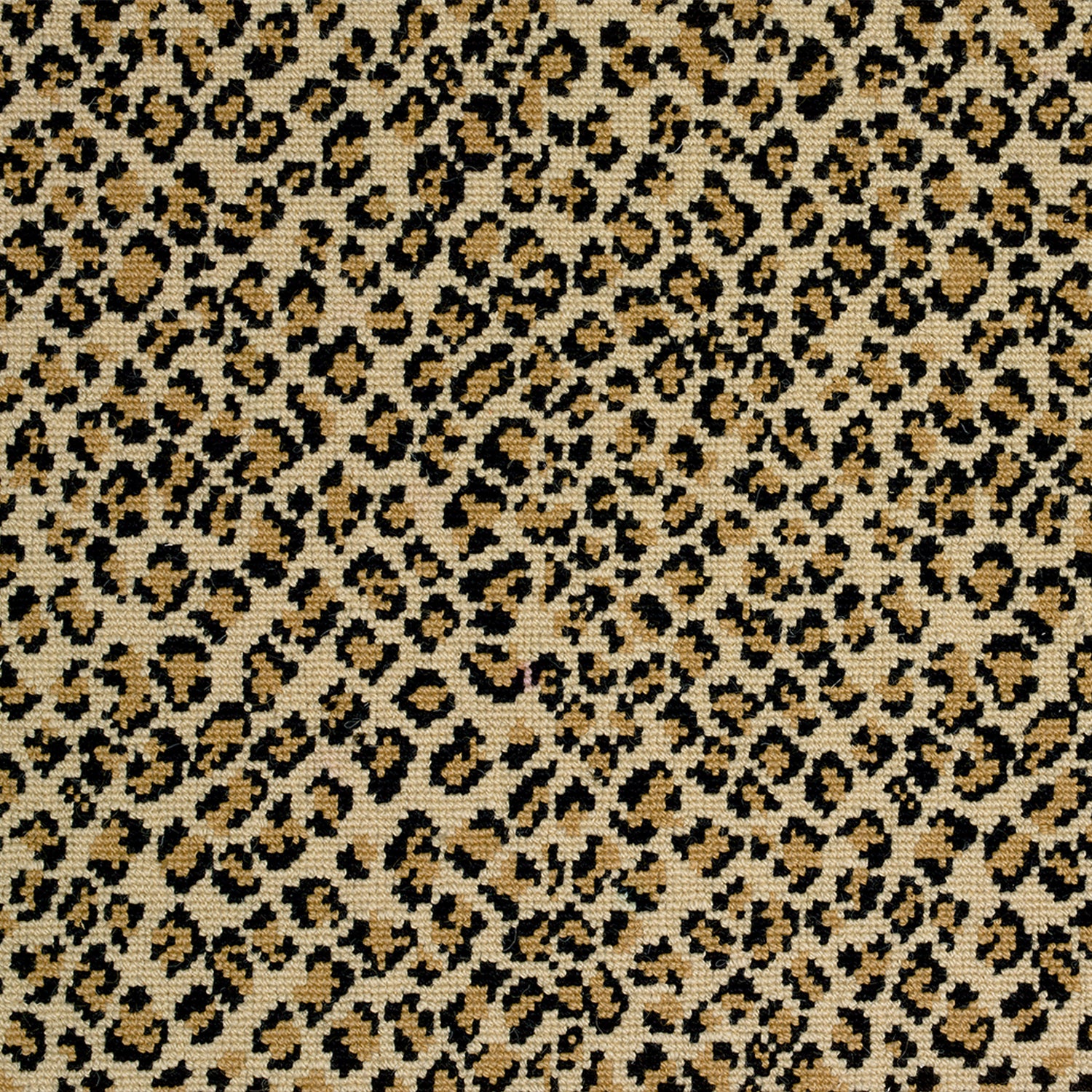 Wool-blend broadloom carpet swatch in a small scale animal print pattern in black and gold on a tan field.
