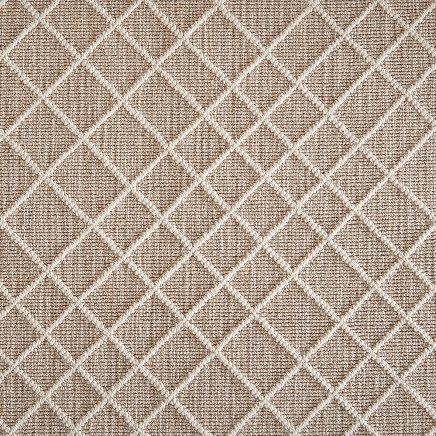 Wool-blend broadloom carpet swatch in a dimensional lattice print in cream on a mottled tan field.