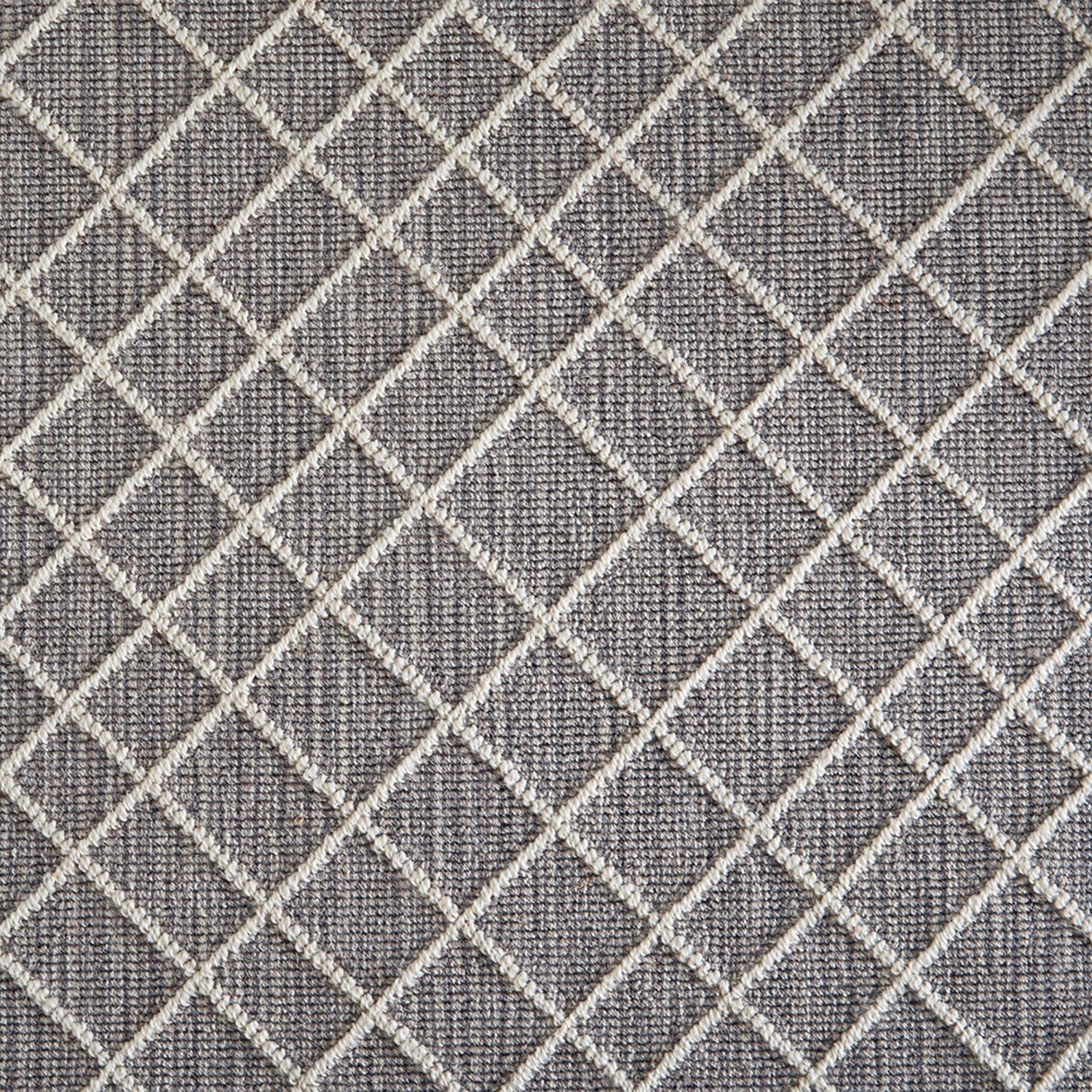 Wool-blend broadloom carpet swatch in a dimensional lattice print in cream on a mottled gray field.