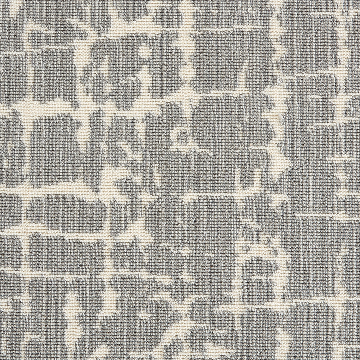 Wool-blend broadloom carpet swatch in an abstract grid pattern in tan on a mottled gray field.