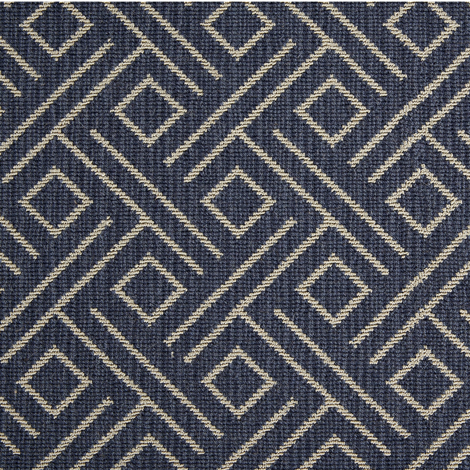 Wool-blend broadloom carpet swatch in a geometric line and square pattern in tan on a navy field.