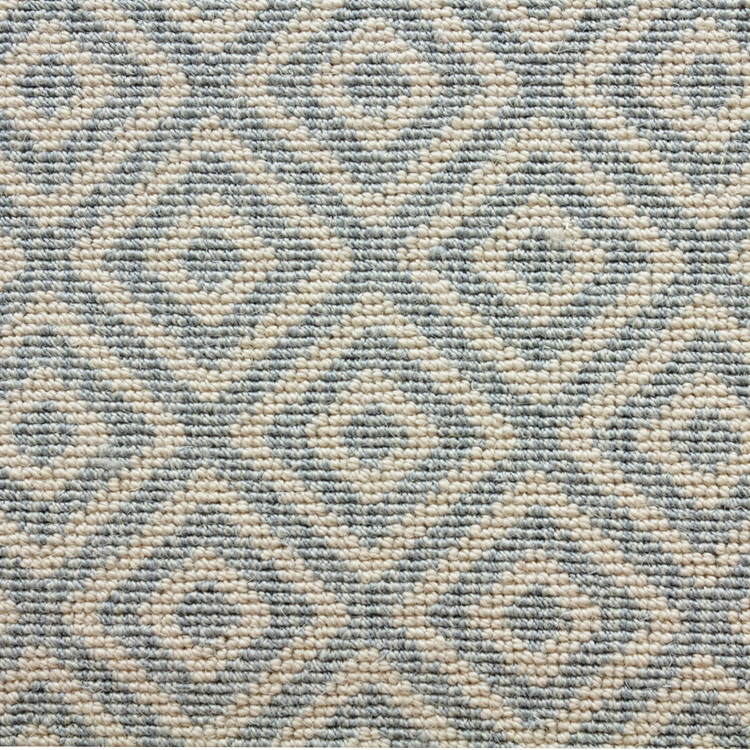 Wool-blend broadloom carpet swatch in a repeating diamond print in blue on a cream field.