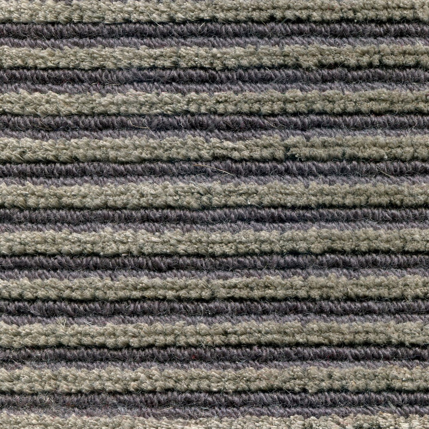 Wool-linen broadloom carpet swatch in a chunky striped weave in shades of tan and dark purple.