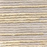 Wool-silk broadloom carpet swatch in a dimensional broken stripe pattern in silver and tan.