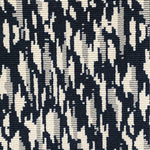 Wool-blend broadloom carpet swatch in a repeating abstract print in cream and silver on a dark navy field.