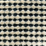 Wool-silk broadloom carpet swatch in a dimensional flat-and-tufted grid weave in cream and charcoal.