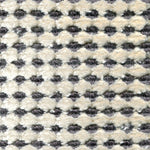 Wool-silk broadloom carpet swatch in a dimensional flat-and-tufted grid weave in cream and gray.