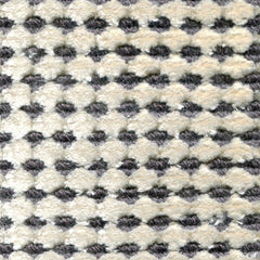 Wool-silk broadloom carpet swatch in a dimensional flat-and-tufted grid weave in cream and gray.
