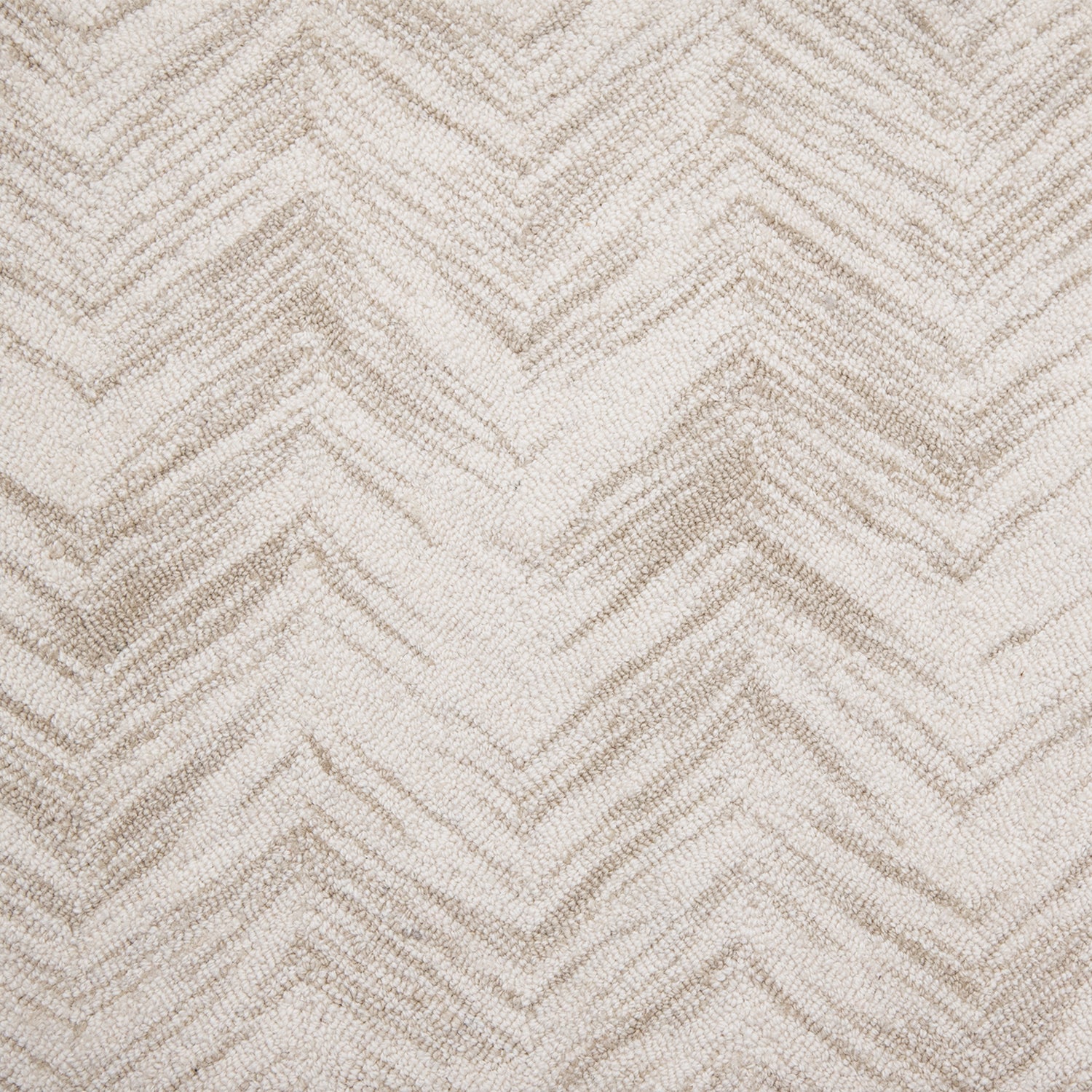 Wool broadloom carpet swatch in a painterly herringbone print in tan on a cream field.