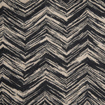 Wool broadloom carpet swatch in a painterly herringbone print in charcoal on a tan field.